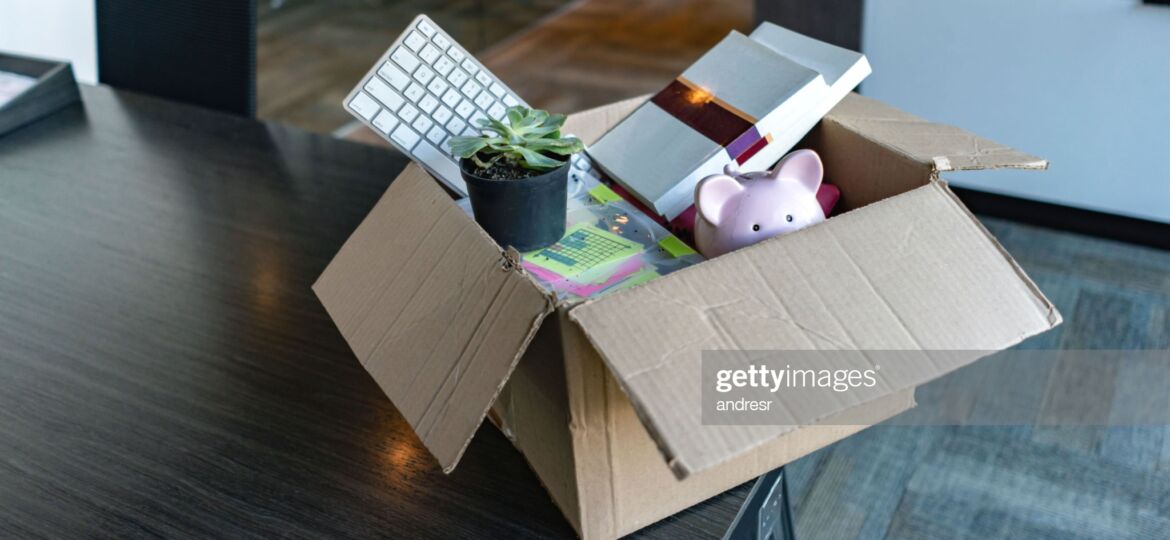 Moving office and packing belongings in a box or getting fired