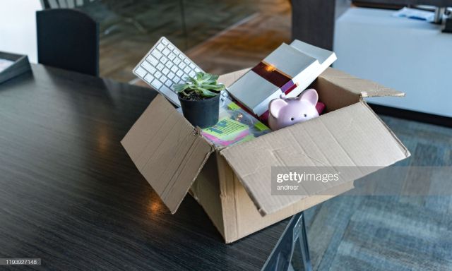 Moving office and packing belongings in a box or getting fired